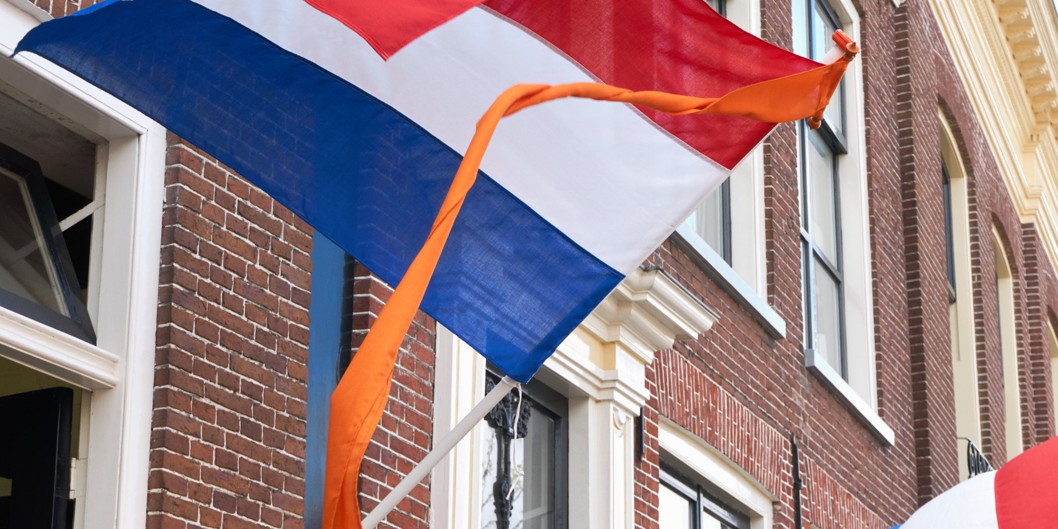 Dutch,Flags,With,Orange,Streamer,Waving,In,The,Wind,On